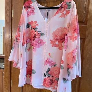 Beautiful floral pink  blouse w/Bell sleeves.small pearls in front of blouse.